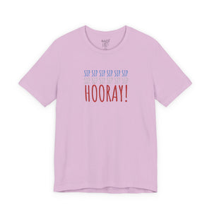 Pink t-shirt with embroidered red white and blue text design on a white background