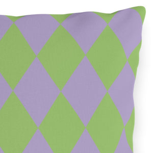 Decorative pillow with green and purple diamond pattern on a white background