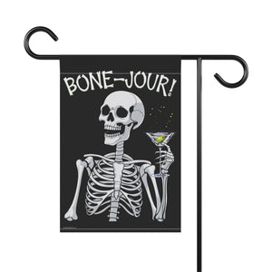 Yard flag and banner with a skeleton holding a martini that says Bone-jour at the top on a black background.