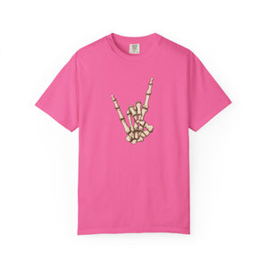 A bright pink  t-shirt with skeleton hand making 'rock on' gesture on a white background