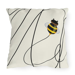 Two square throw pillows with a white background featuring a black line pattern and a cute bee design in the center.