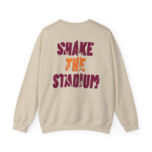 A beige crewneck sweatshirt shown from the back, featuring the text 'SHAKE THE STADIUM' printed in distressed maroon and orange lettering.