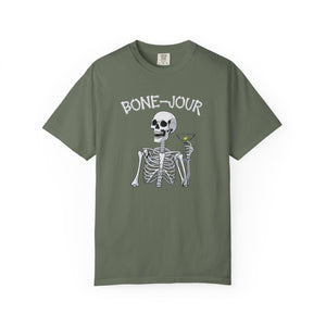 Olive Green t-shirt with a graphic of a skeleton holding a martini with Bone-Jour in bone style lettering at the top.