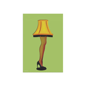 A square art print featuring a stylized illustration of the 'Lamp of the Damned' from The Addams Family. The design shows a yellow fringed lampshade, a leg in red-and-black fishnet stockings, and a black high heel, all set against a solid light green background.
