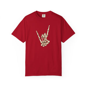A red short-sleeve crewneck t-shirt featuring a graphic of a skeletal hand making the rock on gesture on the chest, displayed against a solid white background.