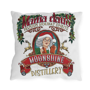 A square white throw pillow featuring a vintage-style holiday graphic with the text 'Mama Claus Premium Holiday Spirits' and 'Moonshine Distillery,' plus an illustrated elderly woman in a Santa hat, holly, reindeer, and red banners.