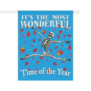 Decorative flag with skeleton and text 'It's the most wonderful time of the year' on a blue background.