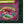 A close-up of a product label or package design featuring an illustrated mermaid with red hair and a green tail on a pink background, with text reading 'The Salty Mermaid' and 'Stay Salty.' The product itself is partially visible against a dark textured background, and the brand name 'Wicked Cat' appears at the bottom left.