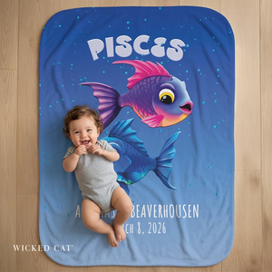 Baby lying on a blue blanket with Pisces design and personalized text