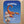 Baby lying on a blanket with a cartoon scorpion and personalized text on a wooden surface
