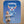 Baby sitting on a blue blanket with a cartoon Taurus character and text.