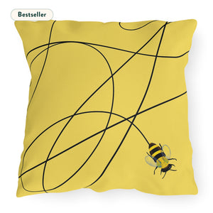 A square yellow throw pillow with a black line pattern and a small illustration of a bee in the corner. The word 'Bestseller' appears in the top left corner.