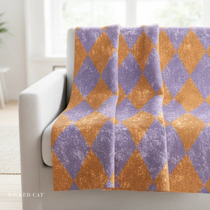 Harlequin Patterned blanket draped over a chair 
