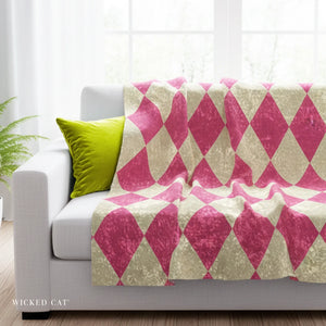 Pink and cream harlequin throw on a grey sofa