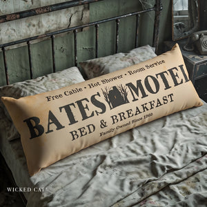 Decorative body pillow that reads Bates Motel Bed & Breakfast on an old bed Halloween decor.