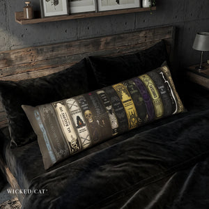 a decorative body pillow with a row of Halloween books design on a bed in a spooky bedroom.