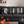Living room scene with a decorative body pillow with a row of Halloween books design.