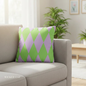 Green and purple patterned pillow on a beige sofa in a living room setting.
