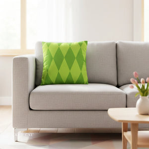 Gray sofa with a green patterned pillow in a bright living room.