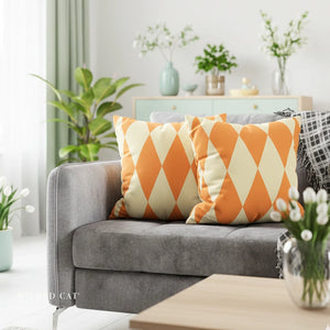 Gray sofa with orange and white patterned cushions in a living room setting.