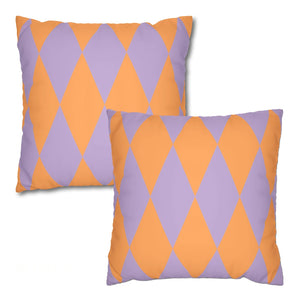Two decorative pillows with orange and purple diamond pattern on a white background