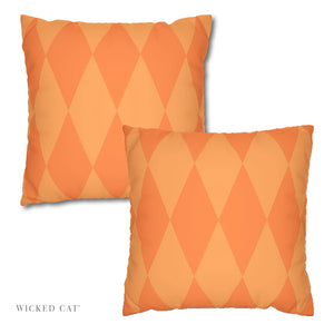 Two orange diamond patterned pillows on a white background with 'Wicked Cat' branding.