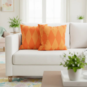 White sofa with orange patterned pillows in a living room setting.