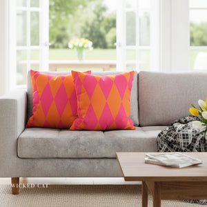 Gray sofa with pink and orange patterned cushions in a bright living room.
