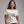 Woman wearing a white t-shirt with text on a gray background