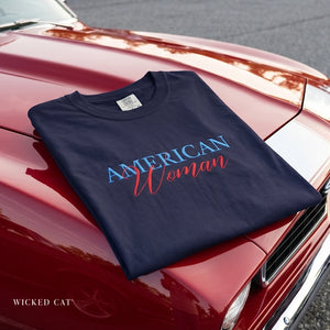 Navy blue t-shirt with 'American Woman' text on a red car