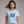 Woman wearing a light blue t-shirt with 'Patriotic AF' text on a plain background