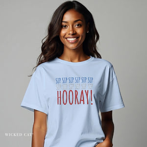 Woman wearing a light blue t-shirt with colorful text on a gray background