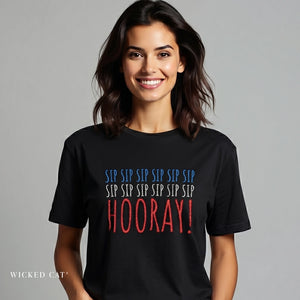 Woman wearing a black t-shirt with colorful text on a gray background