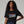 Woman wearing a black t-shirt with 'Semiquincentennial 250 1776-2026' embroidered text on a gray background