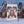 Decorative garden flag for Mama Claus Moonshine Distillery against a festive background with snow-covered buildings.