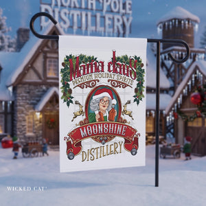Decorative garden flag for Mama Claus Moonshine Distillery against a festive background with snow-covered buildings.