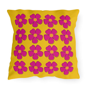 A square-shaped accent pillow with a yellow background and pink floral pattern.