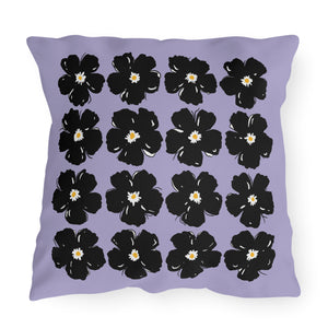 A square-shaped throw pillow with a purple background and black floral patterns