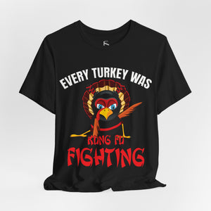 Orange t-shirt with 'Kung Fu Fighting Turkey 80s Music Funny' design on a white background