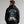 Person wearing a black hoodie with a skull design and text on the back, brand 'Wicked Cat' visible.
