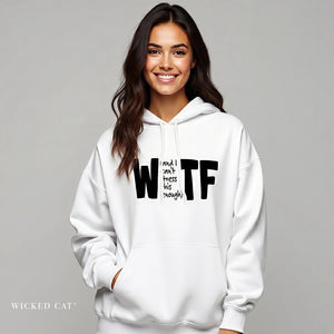 Woman wearing a white hoodie with text, standing against a gray background