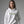 Person wearing a white hoodie with 'Ew, People' text on a gray background