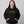 Person wearing a black hoodie with 'Ew, People' text on a gray background