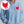 Person wearing a white hoodie with embroidered 'Wicked Heart Women's' design on a plain background