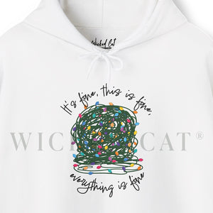 close up of a white sweatshirt hoodie with a graphic of a ball of tangled Christmas lights and text that says 'It's fine, this is fine, everything is fine'.