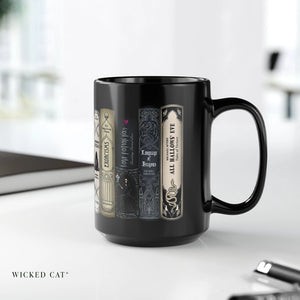 Black coffee mug with Halloween books design on an office desk.