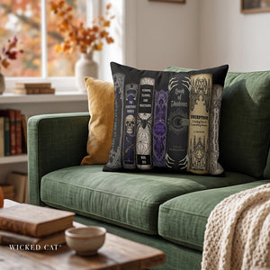 A decorative throw pillow featuring a set of gothic book spines, sits on a green sofa in a cozy living room setting.