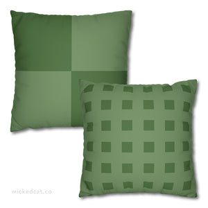 Two green pillows with different geometric checkered patterns on a white background