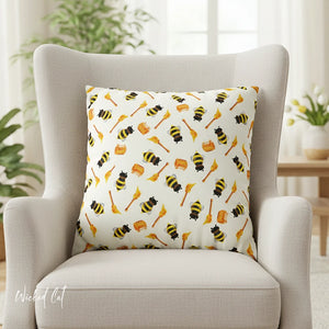 Decorative pillow with bee pattern on a chair in a room with plants and a table.