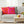 Gray sofa with colorful polka dot pillows and a wooden coffee table with decor items.